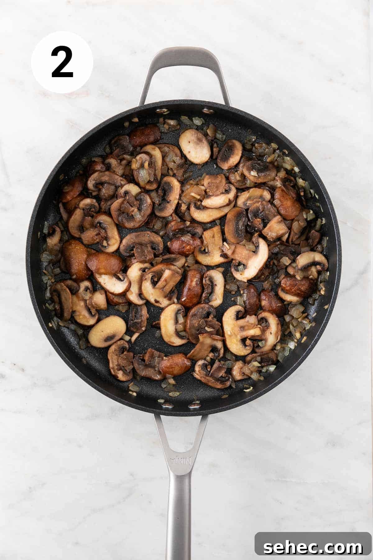 Vegan Mushroom Gravy Recipe 5 Onion, garlic, and mushrooms sautéed in a skillet.