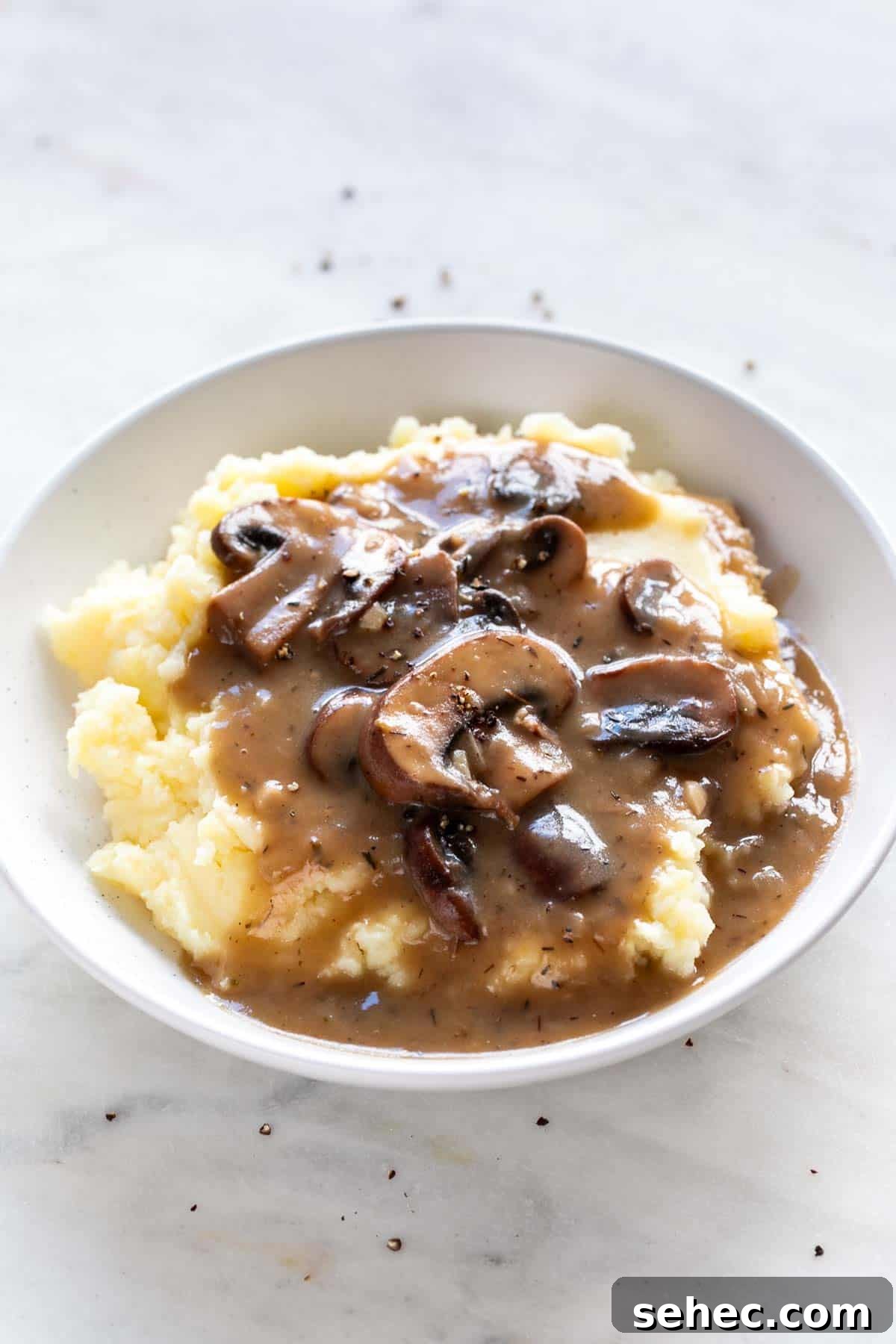 Vegan Mushroom Gravy Recipe 10 Plate with vegan mushroom gravy over vegan mashed potatoes.