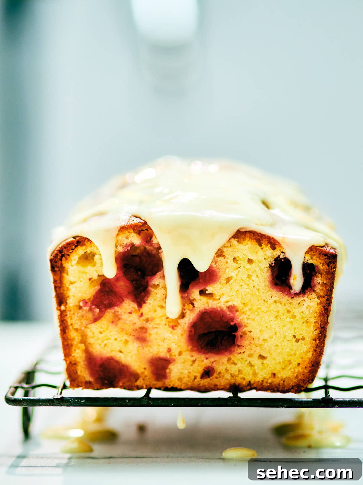 Orange glaze on top of a vanilla cranberry pound cake.