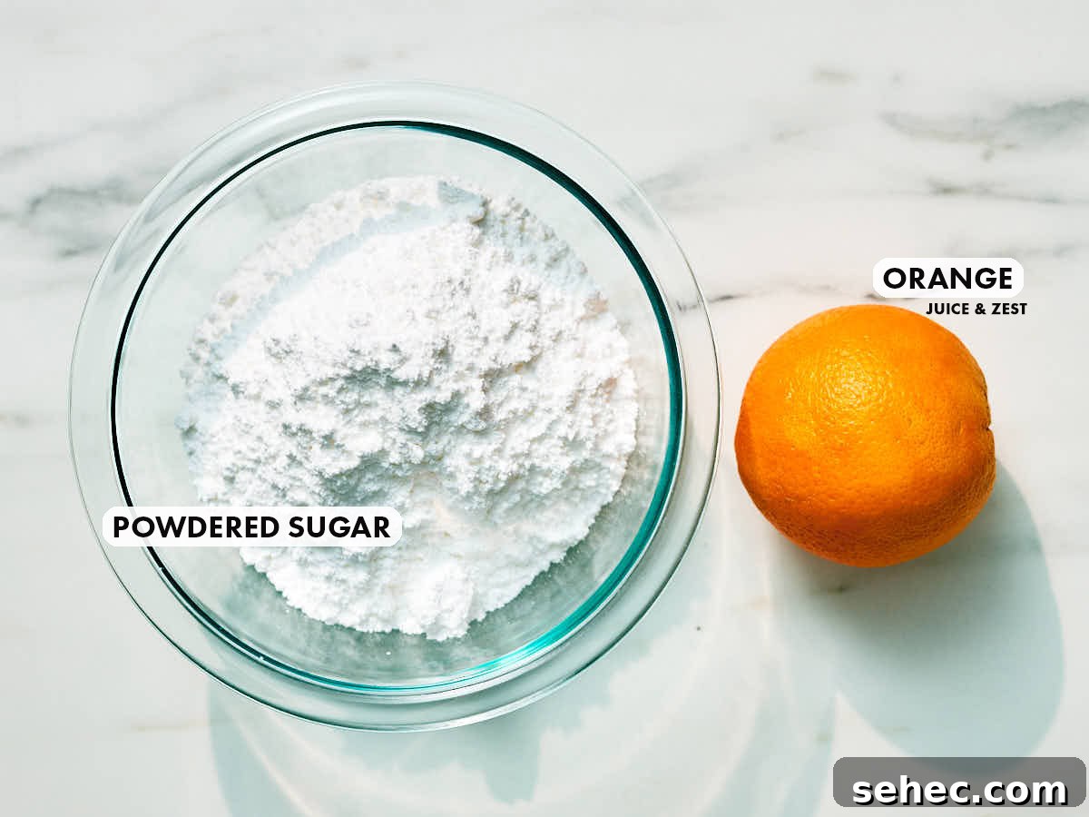 Ingredients (powdered sugar, fresh orange) to make orange icing.