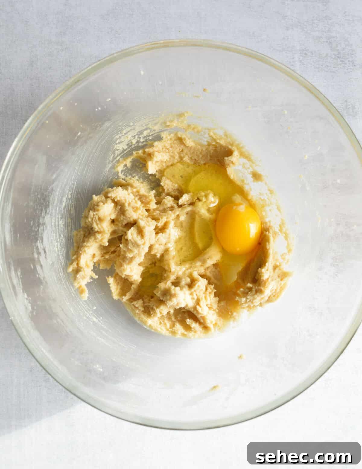 Chewy Almond Flour Chocolate Chip Cookies 6 creamed butter and sugar in a bowl with an egg on top.