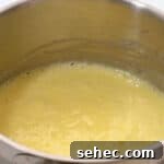 Boston Cream Pie Donuts with Chocolate Glaze 17 simmering pastry cream in a saucepan.