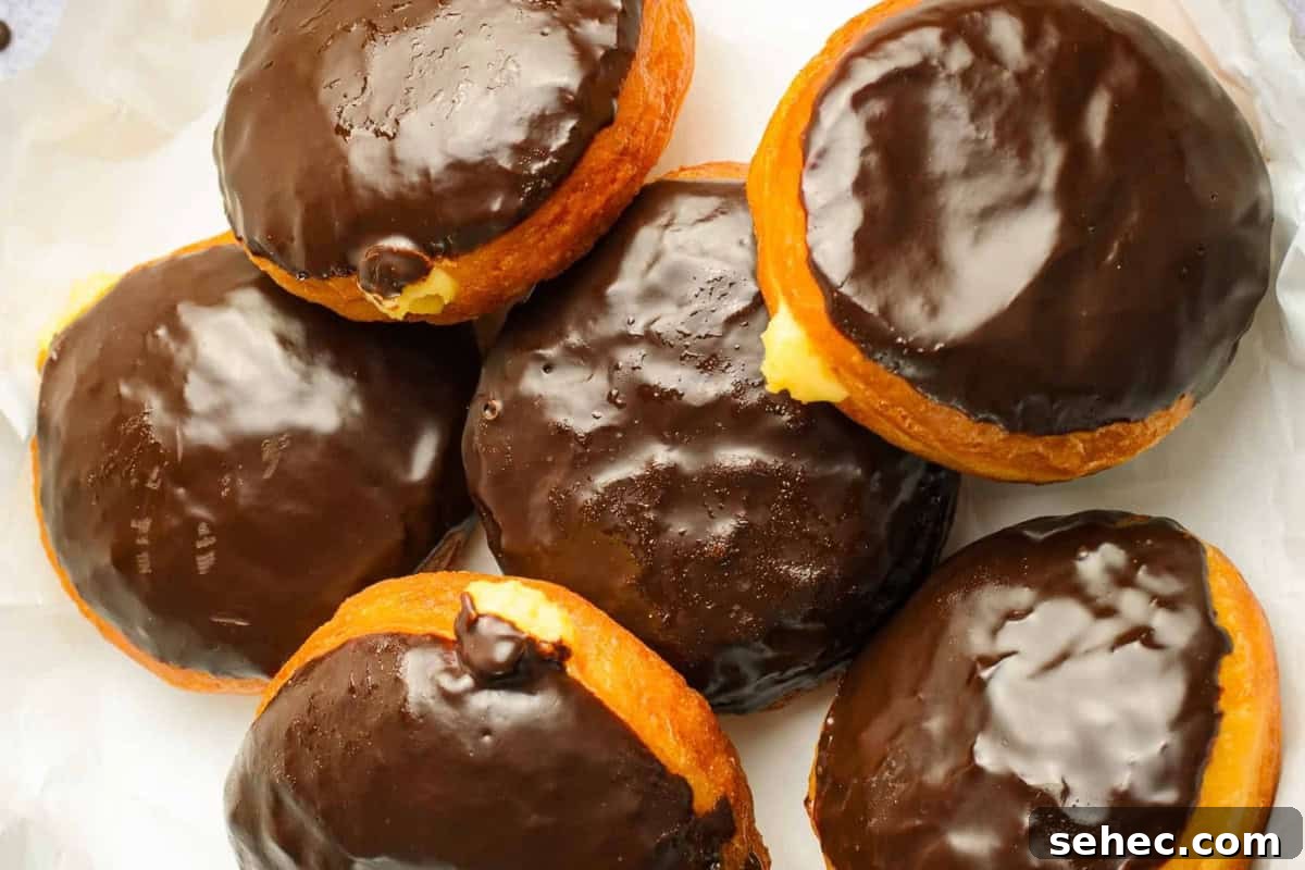 Boston Cream Pie Donuts with Chocolate Glaze 3 overhead view of a pile of boston cream donuts.