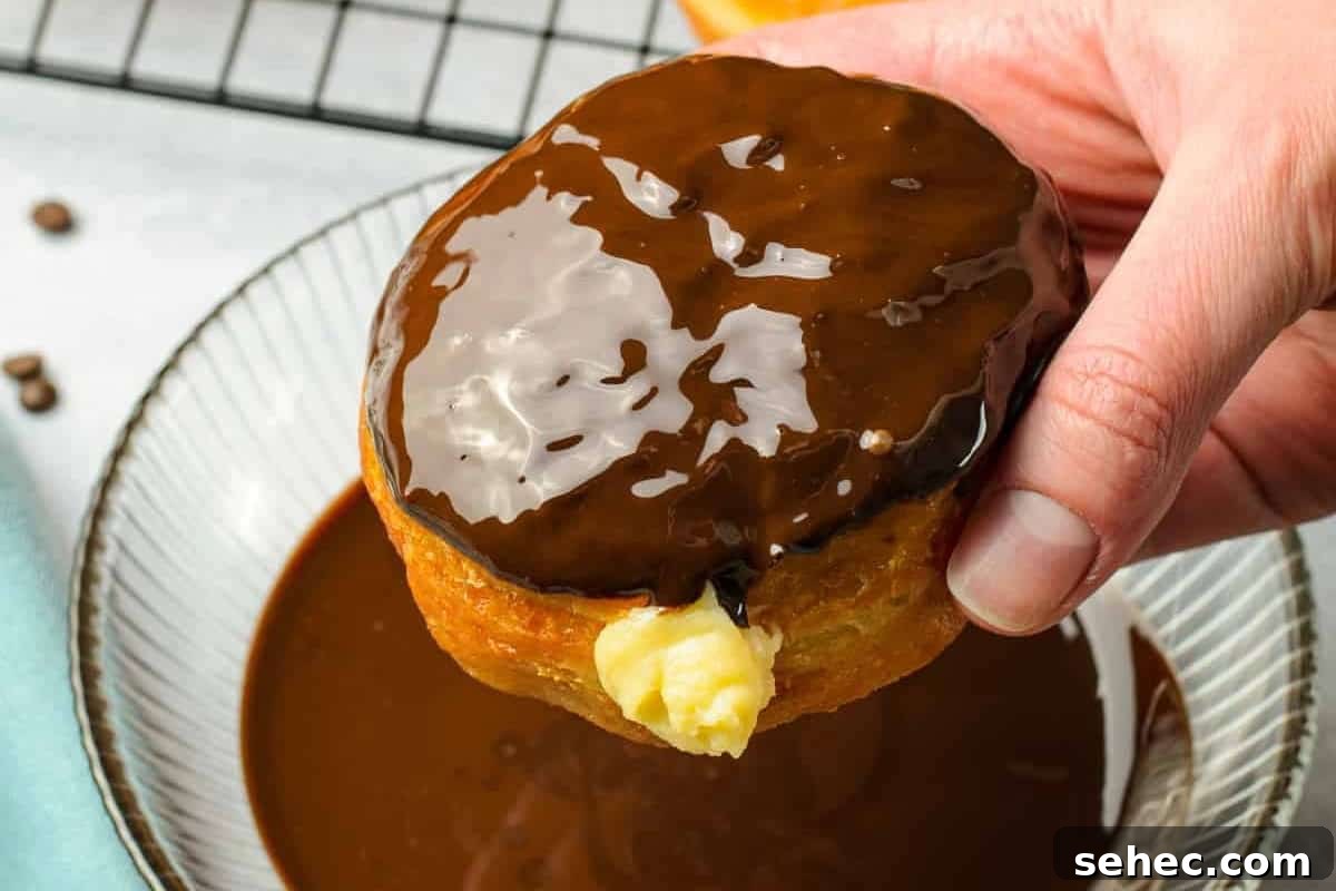 Boston Cream Pie Donuts with Chocolate Glaze 37 a boston cream filled donut dipped in chocolate glaze.