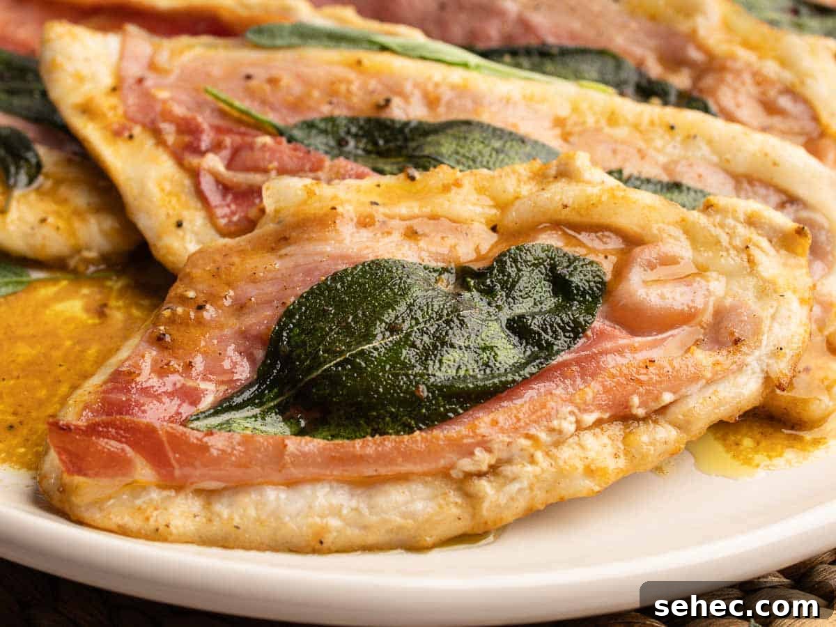 Chicken Saltimbocca with Prosciutto and Sage 13 Close up of chicken cutlets topped with prosciutto and sage leaves.