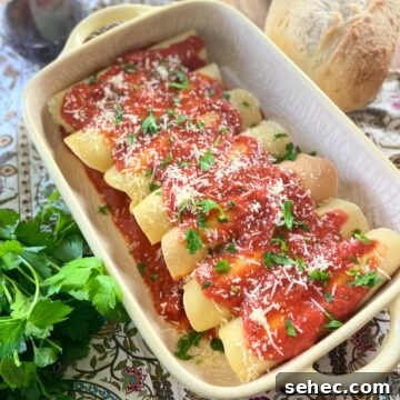 Three Cheese Manicotti Crepes Recipe 11 Manicotti crepes in baking dish.
