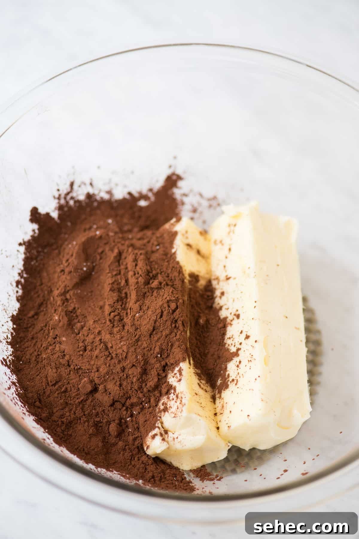 Chocolate Frosting Recipe for Cakes and Cupcakes 4 cocoa powder and butter in glass bowl