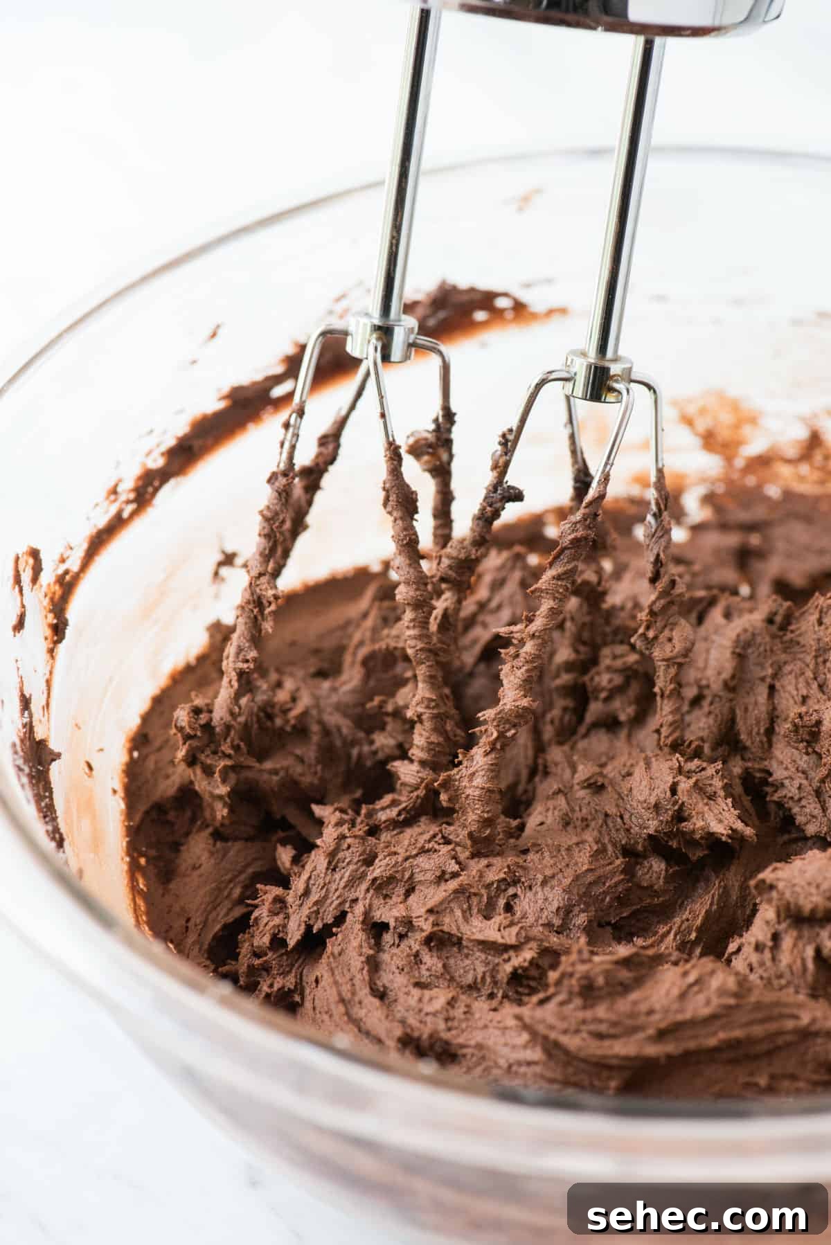 Chocolate Frosting Recipe for Cakes and Cupcakes 5 chocolate frosting in glass mixing bowl with electric mixer