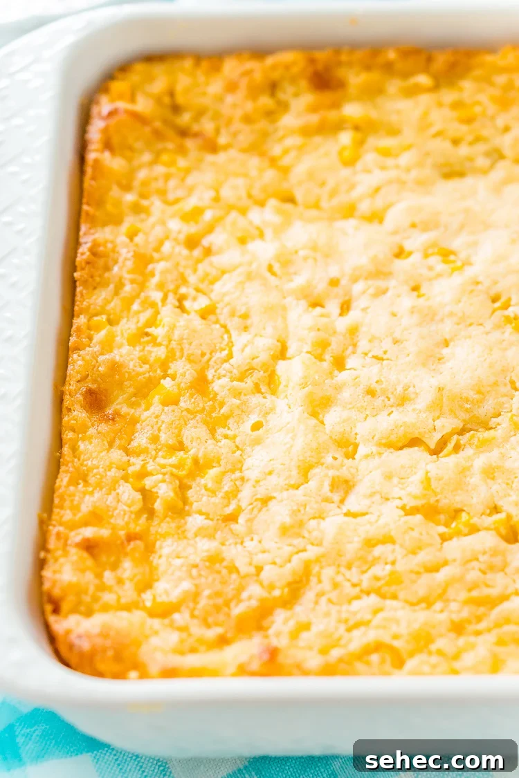 Classic cheesy corn casserole baked in a dish.