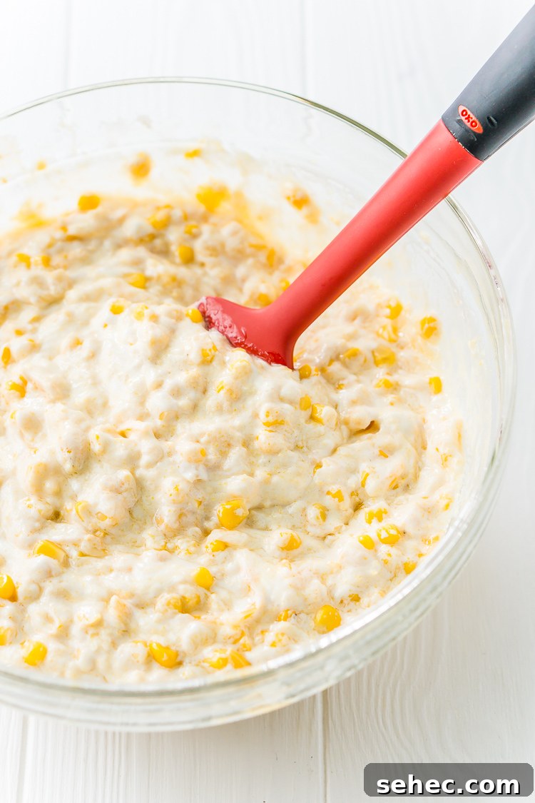 Easy cheesy corn casserole recipe baked until warm and creamy.