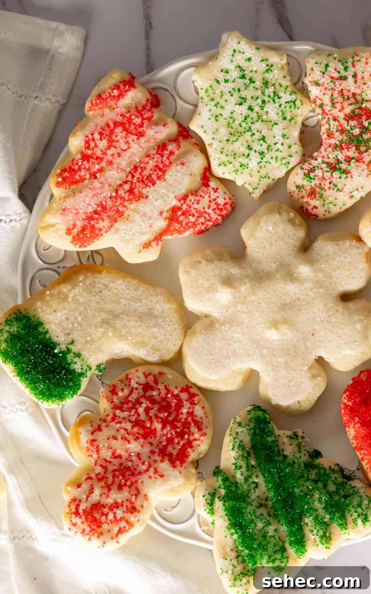 Soft Cream Cheese Sugar Cookies From Scratch 2 Cream cheese sugar cookies decorated with sanding sugar on decorative plate.