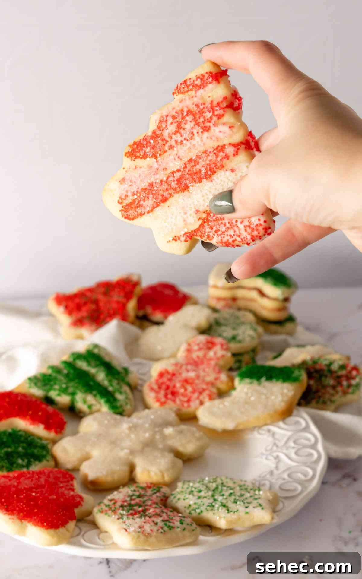 Soft Cream Cheese Sugar Cookies From Scratch 5 A red and white Christmas tree cream cheese sugar cookie with sanding sugar.