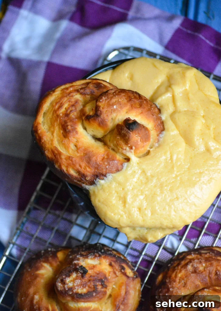 Soft Pretzels Made with Canned Biscuits 6 a baked canned biscuit pretzel shown dunked into a bowl overflowing with cheese sauce