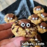 Halloween Spider Cookies Recipe for Spooky Parties 18 Hand holding a spider cookie up close.