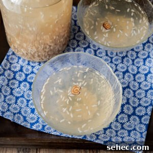 Homemade Sikhye Korean Sweet Rice Drink Recipe 16 Korean rice drink served in glass bowls with jujube flower garnish.