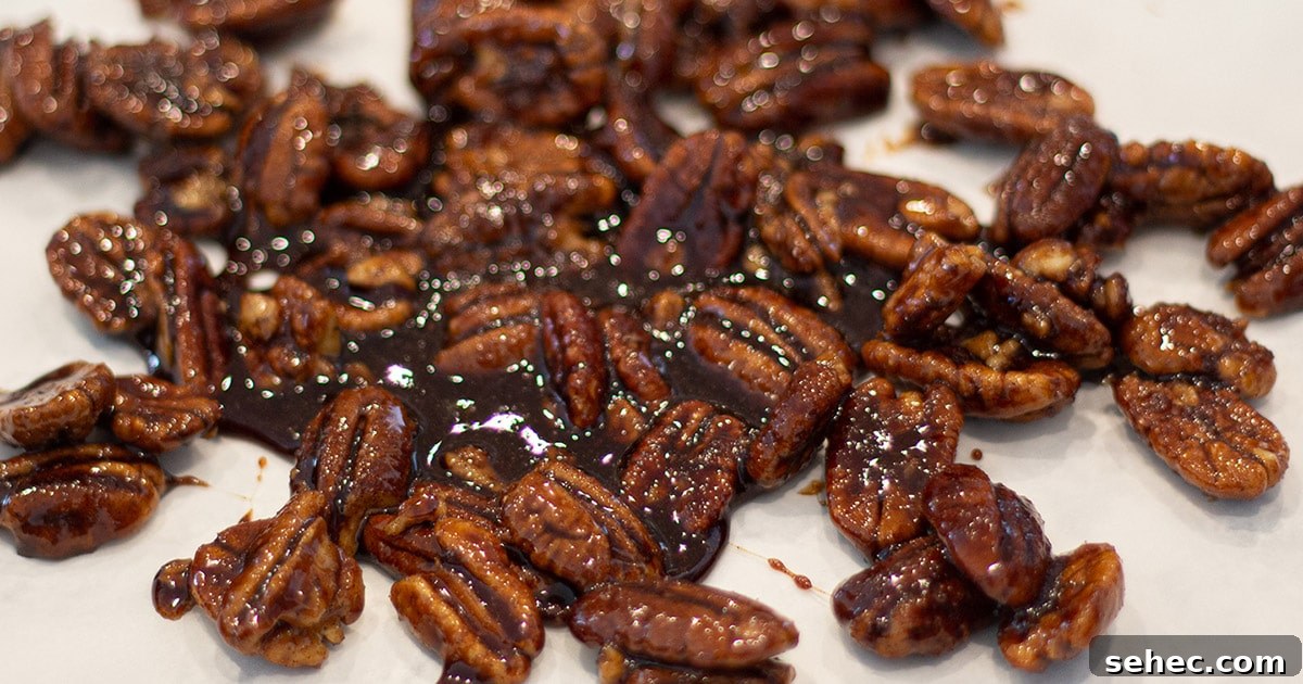 Candied pecans cooling on a piece of wax paper