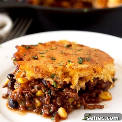 Brown Butter Cornbread Tamale Pie 7 Close up view of a piece of cornbread tamale pie on a white plate