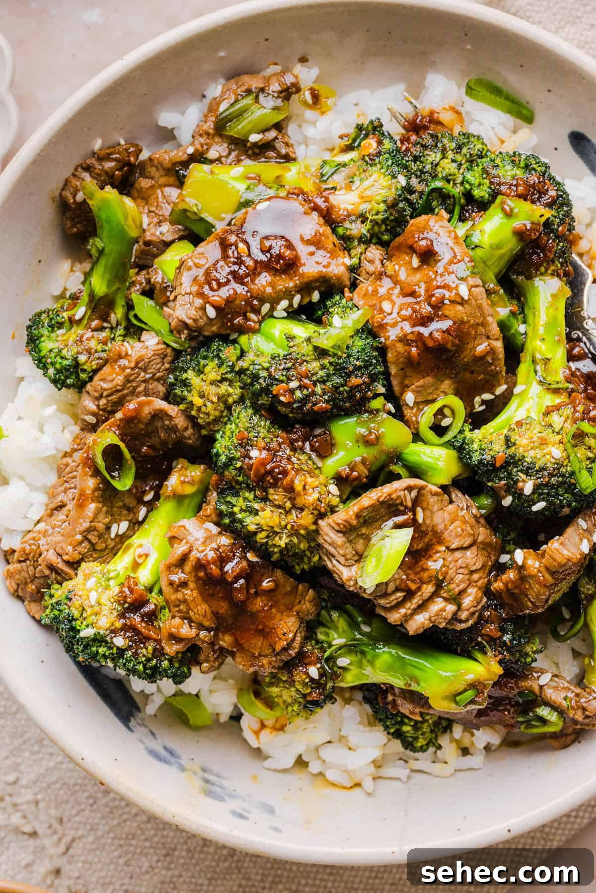 Beef and Broccoli Stir Fry Recipe 7 Healthy Beef and Broccoli plated with sauce and sesame seeds.
