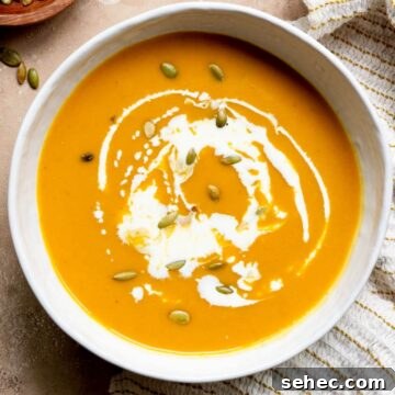 Creamy, dairy-free one-pot carrot and butternut squash soup with coconut milk and pumpkin seed.