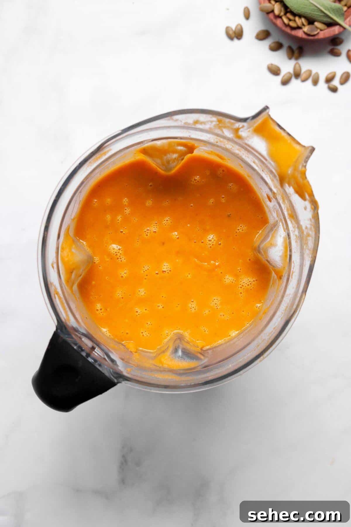 Creamy Pumpkin Sweet Potato Soup Recipe 7 Blending sweet potato and pumpkin soup in a blender until silky smooth.