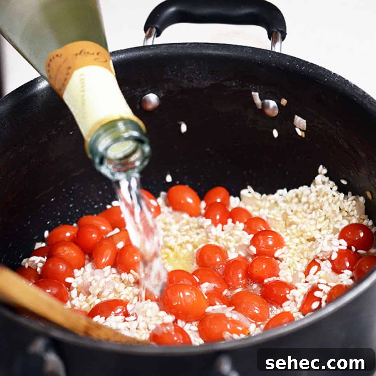 Creamy Tomato Risotto 6 Adding white wine to tomato risotto.