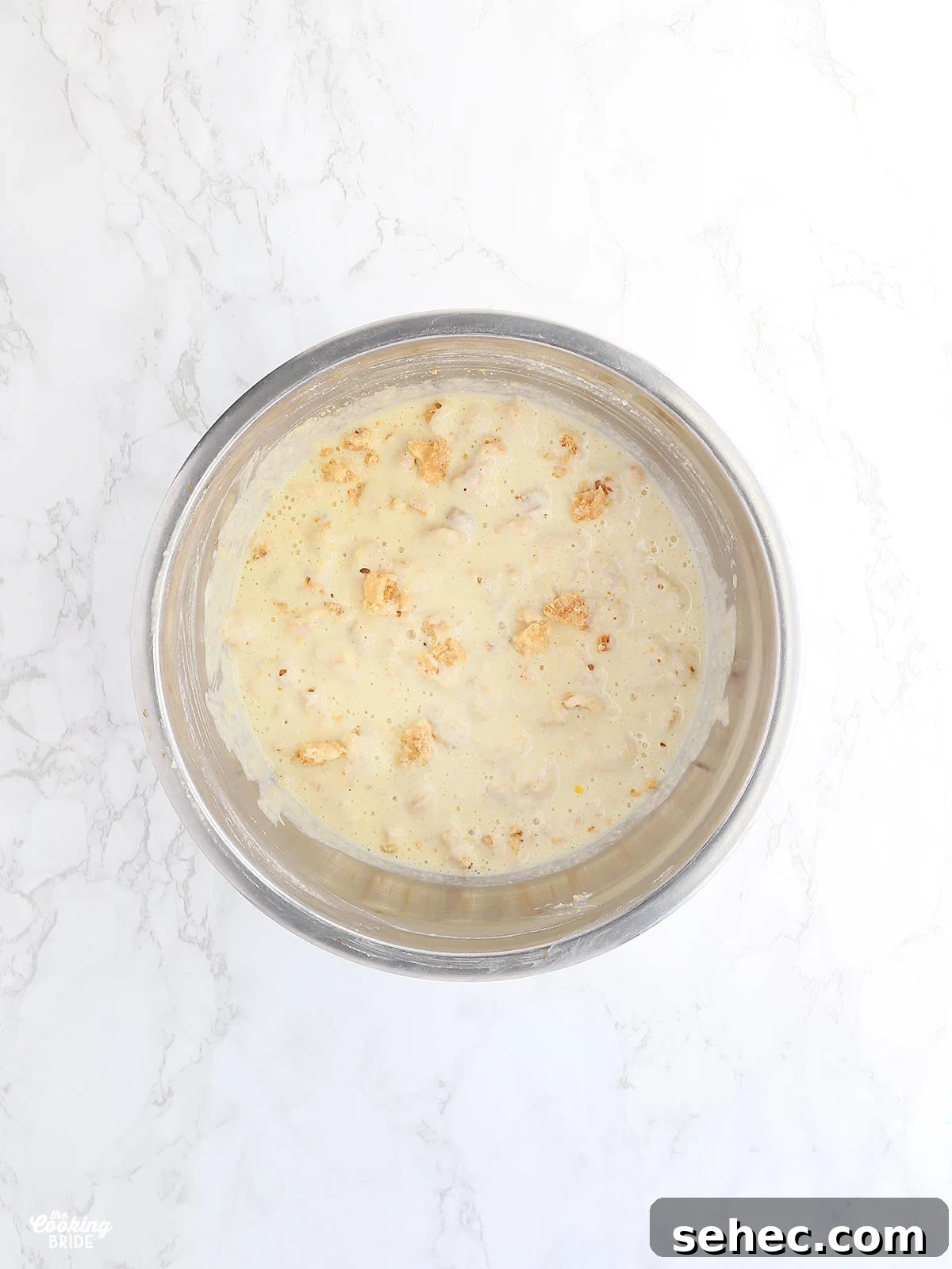 Southern Cracklin Cornbread Recipe 12 mixed cracklin corn bread batter in a stainless steel mixing bowl