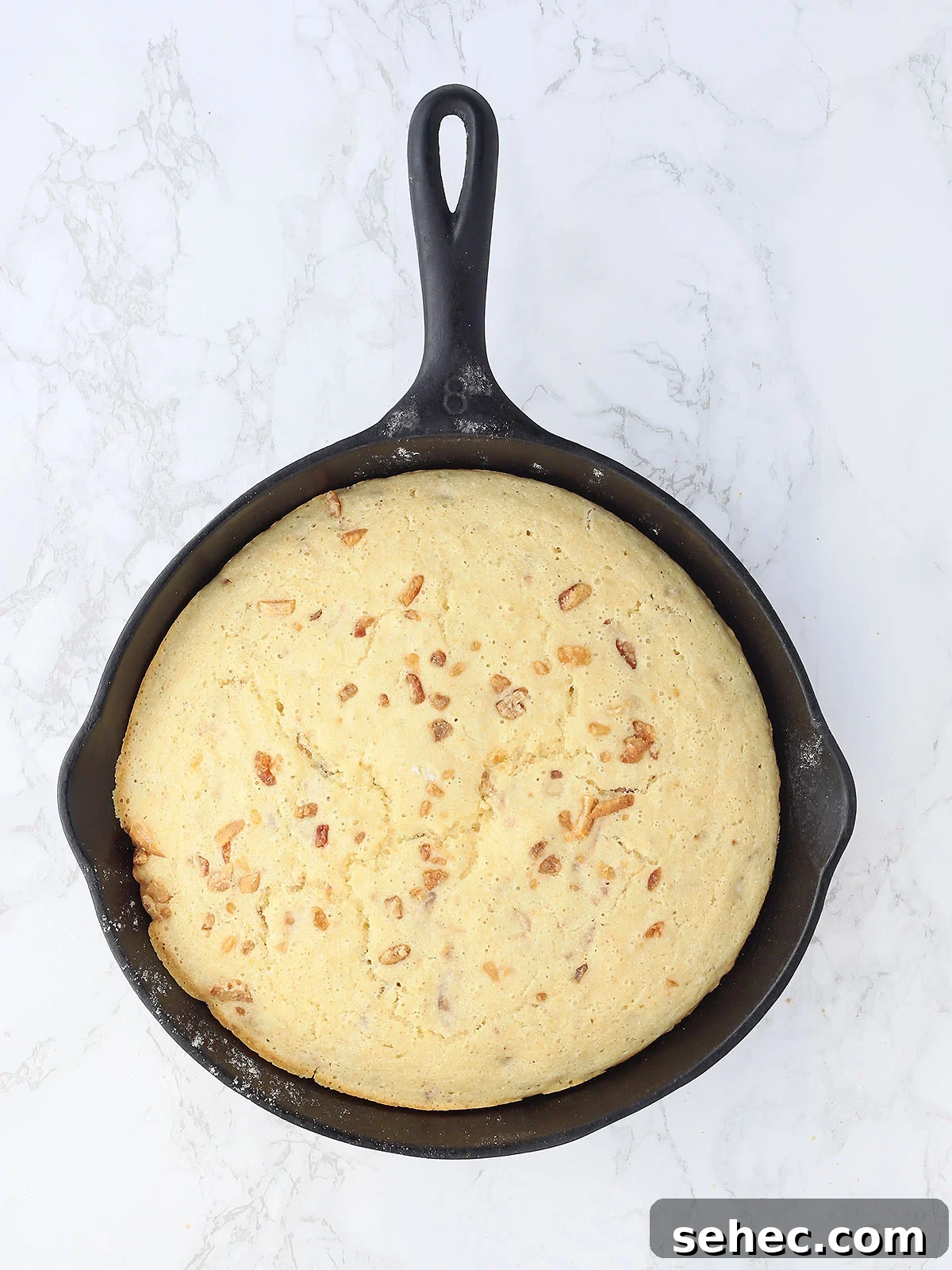Southern Cracklin Cornbread Recipe 15 baked cracklin' corn bread in a cast iron skillet after it has come out of the oven