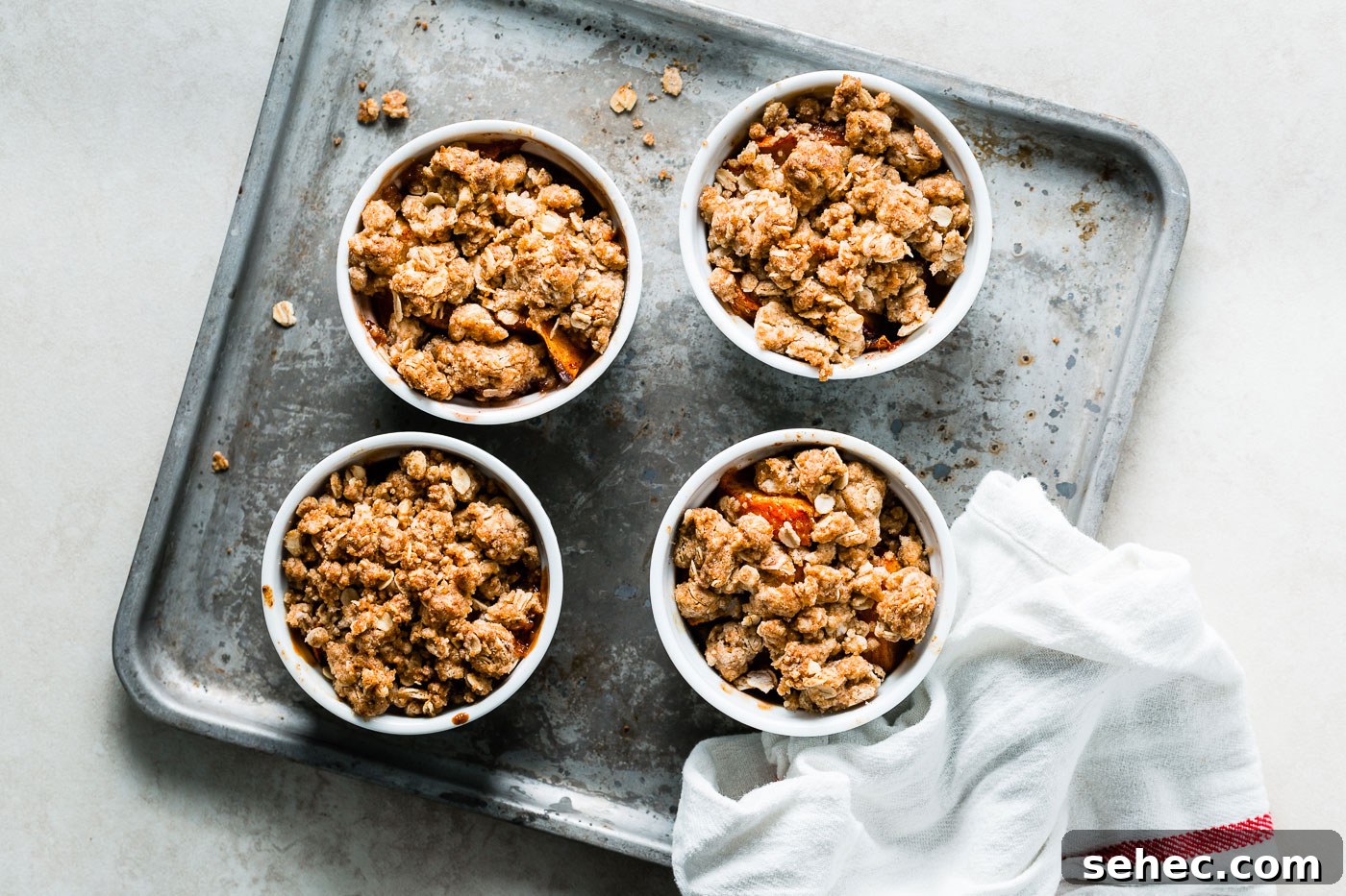 individual peach crumbles on sheet pan
