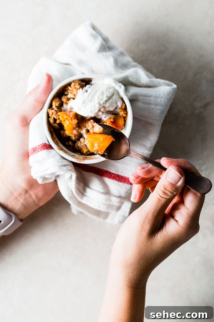 eating individual peach crumble