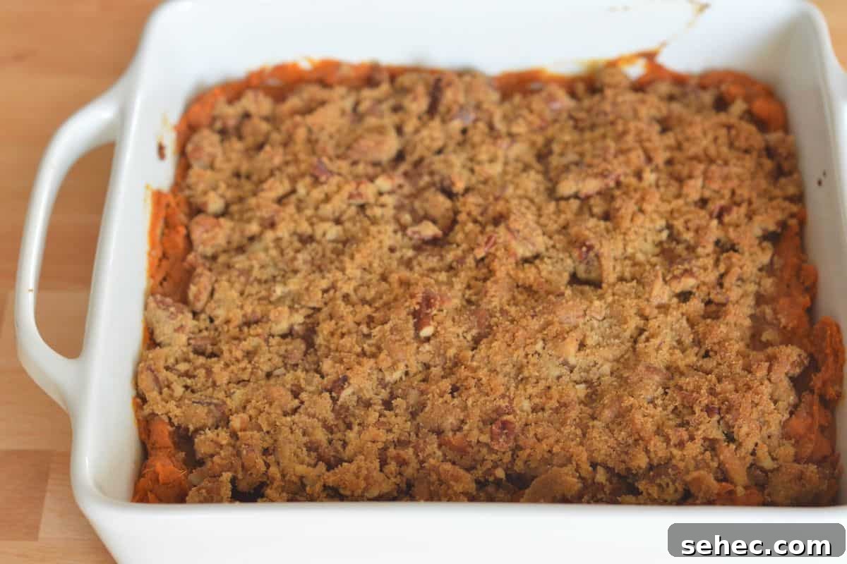 Eggless Sweet Potato Casserole with Pecan Streusel 3 Sweet Potato Casserole with Pecan Streusel Topping in a white casserole dish.