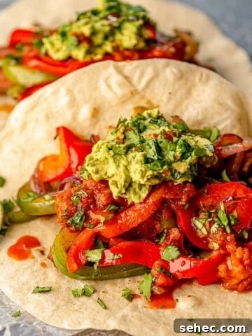 A fajita topped with guacamole.