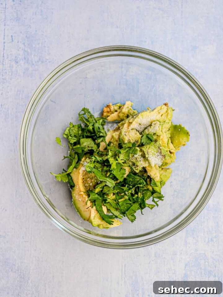 Ground Chicken Tacos with Juicy Mexican Seasoning 5 Guacamole ingredients in a bowl.