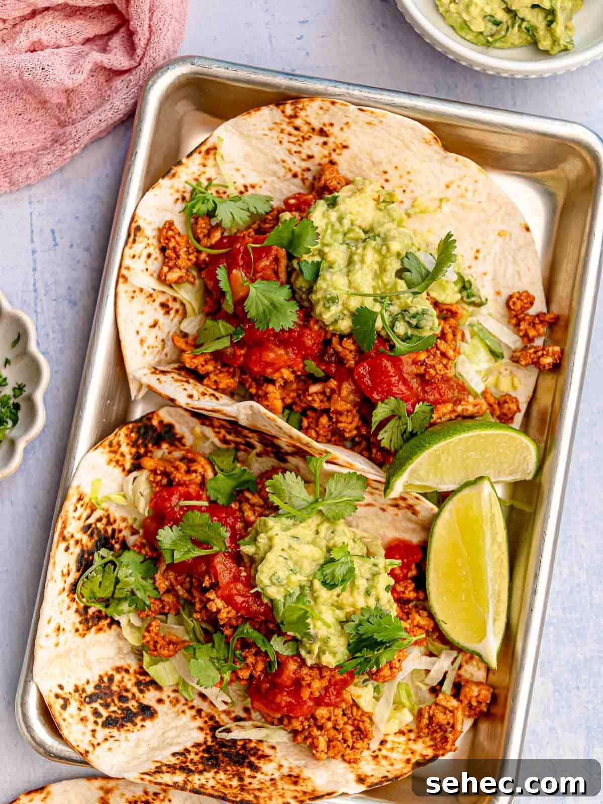Ground Chicken Tacos with Juicy Mexican Seasoning 7 Two chicken tacos on a silver tray.