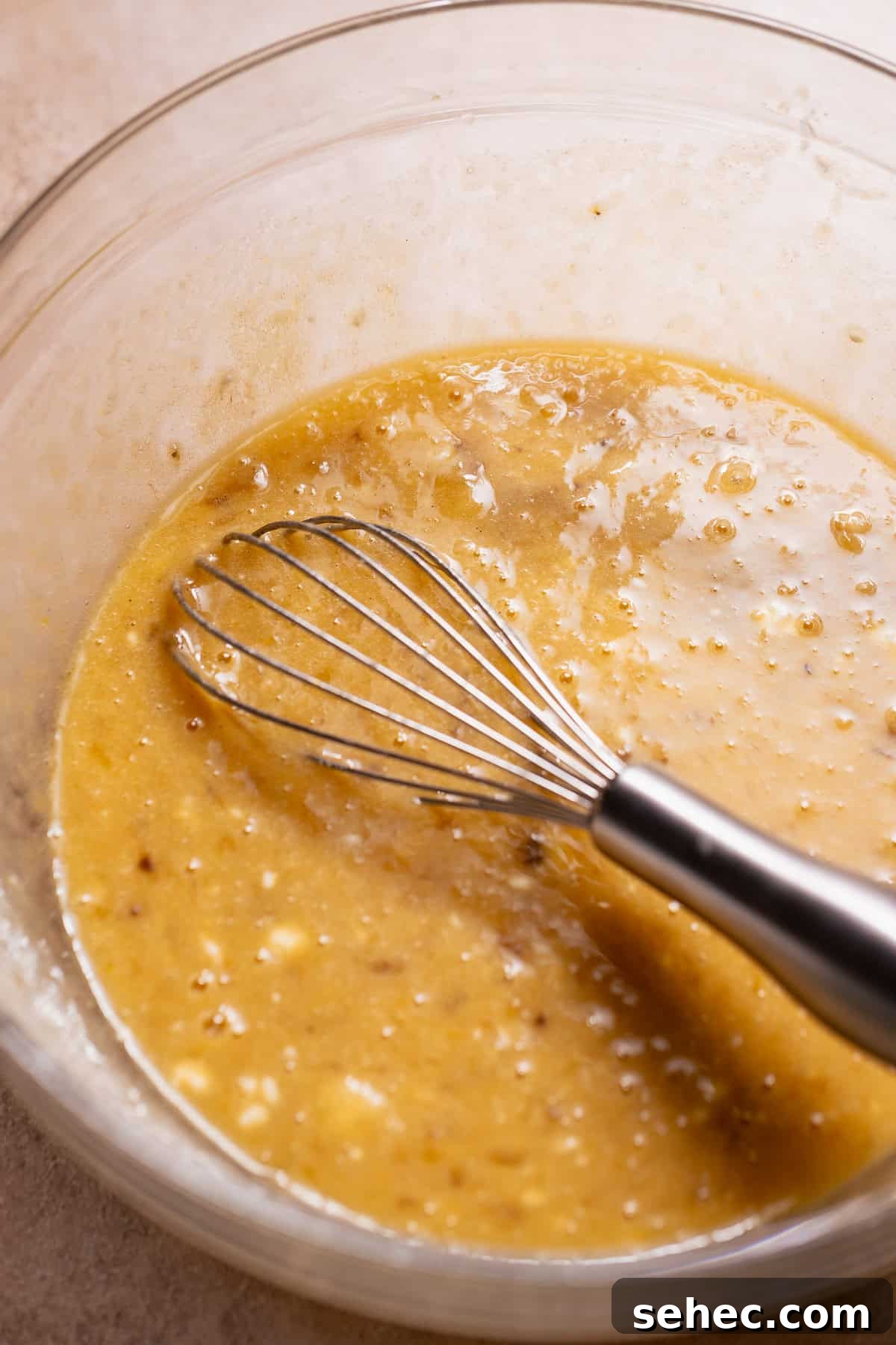 Sugar Crusted Blueberry Banana Bread 3 Whisking mashed bananas with wet ingredients for blueberry banana bread batter.