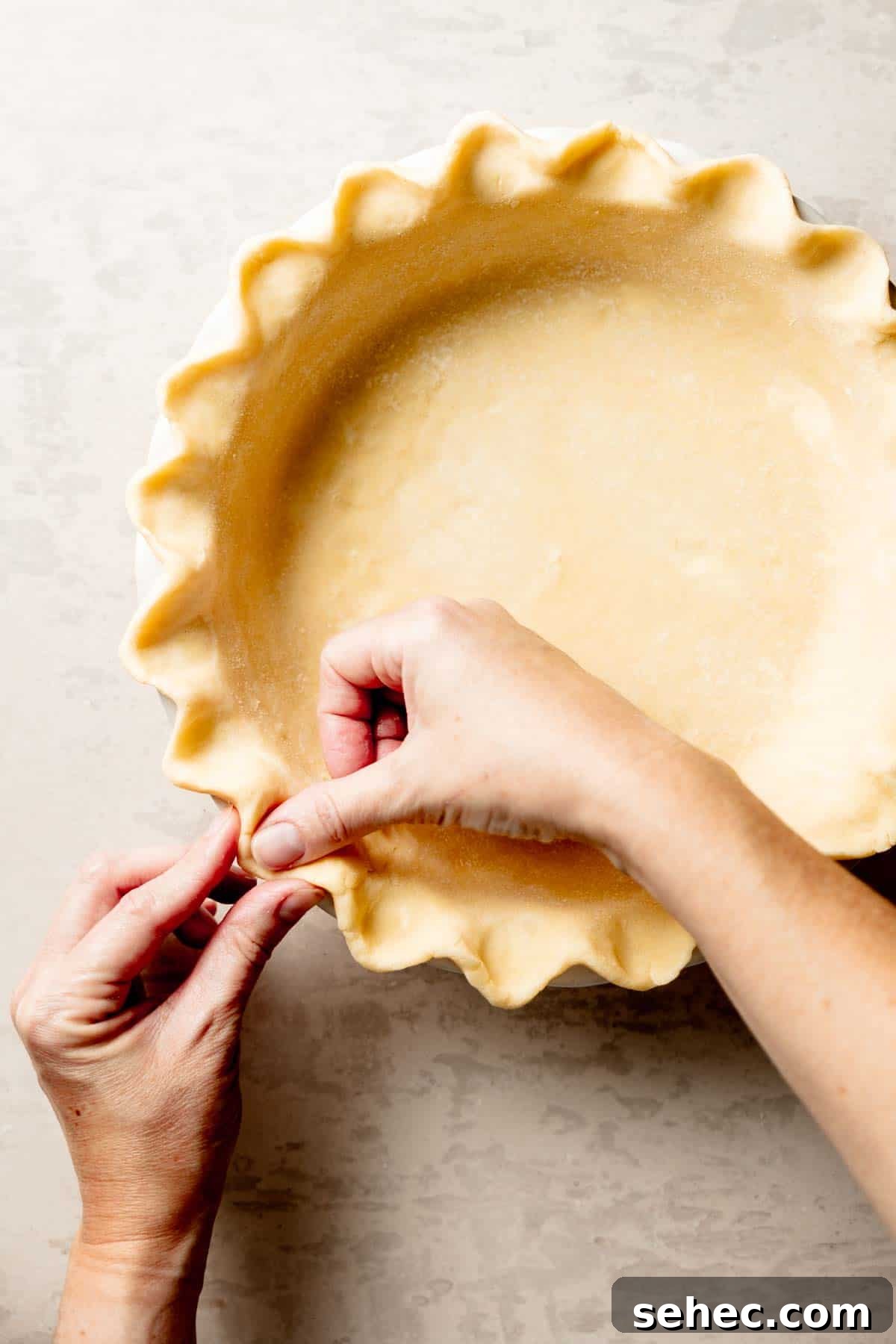 Gluten Free Pecan Pie Recipe with Classic Southern Flavor 5 Hands crimping gluten-free pie crust in pie dish.