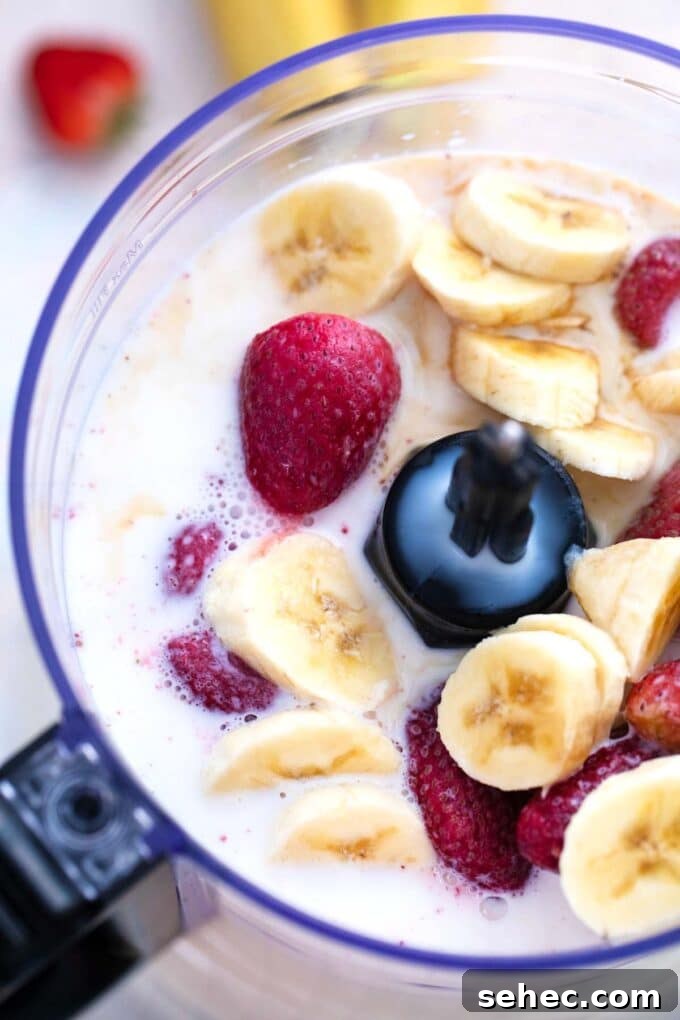 Creamy Strawberry Banana Smoothie Recipe 5 Strawberry banana smoothie ingredients in a blender.