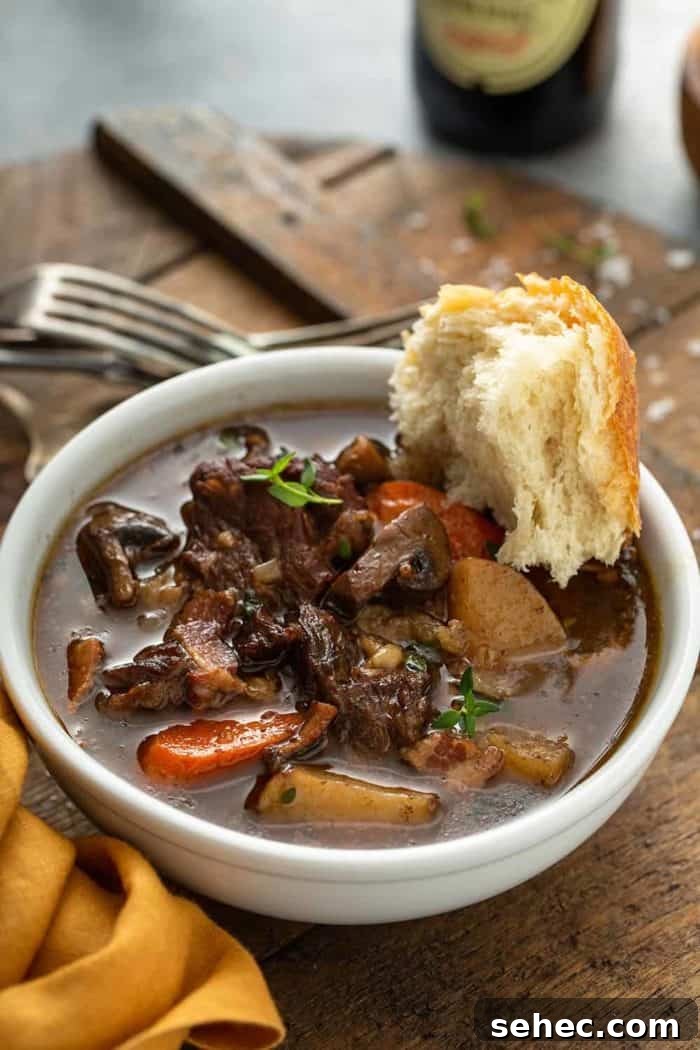 Slow Cooker Beef and Barley Stew Recipe 2 Crusty bread dipped into a bowl of beef and barley stew