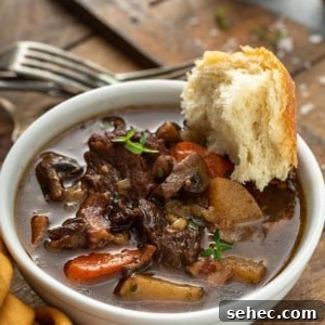 Slow Cooker Beef and Barley Stew Recipe 17 Crusty bread dipped into a bowl of beef and barley stew