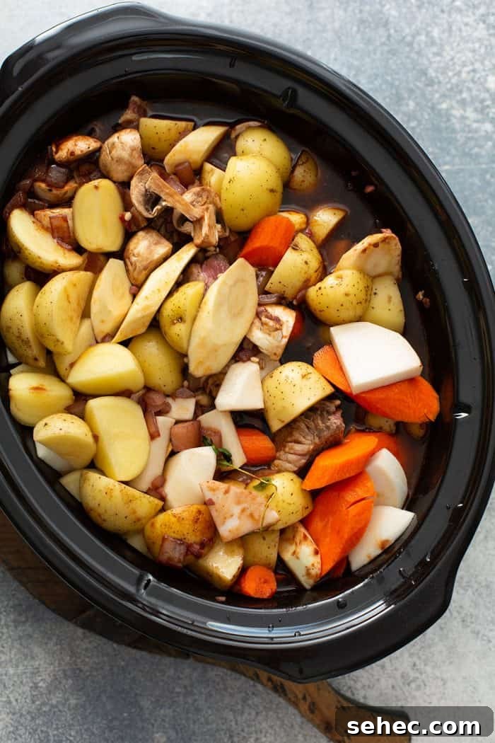 Slow Cooker Beef and Barley Stew Recipe 8 Ingredients for beef and barley stew in a slow cooker, ready to be cooked