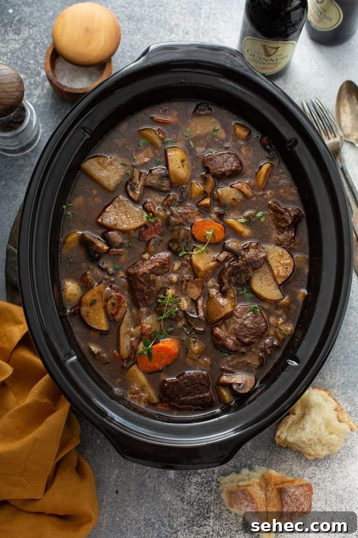 Slow Cooker Beef and Barley Stew Recipe 9 Overhead view of cooked beef and barley stew in a slow cooker