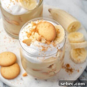 Homemade Banana Pudding Recipe From Scratch 17 Two glasses of gluten free banana pudding sitting on a marble tray.