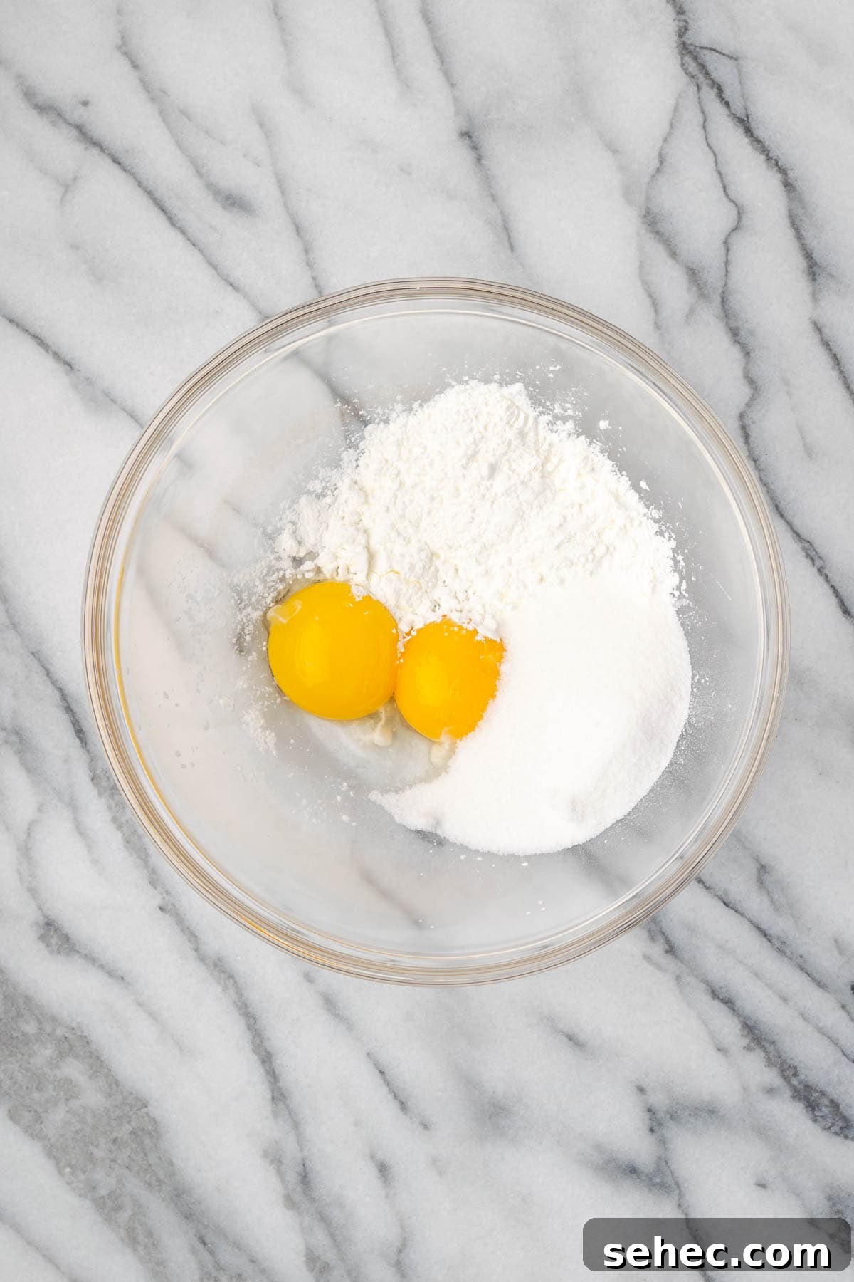 Homemade Banana Pudding Recipe From Scratch 4 Egg yolks, cornstarch and sugar combined in a large glass mixing bowl.