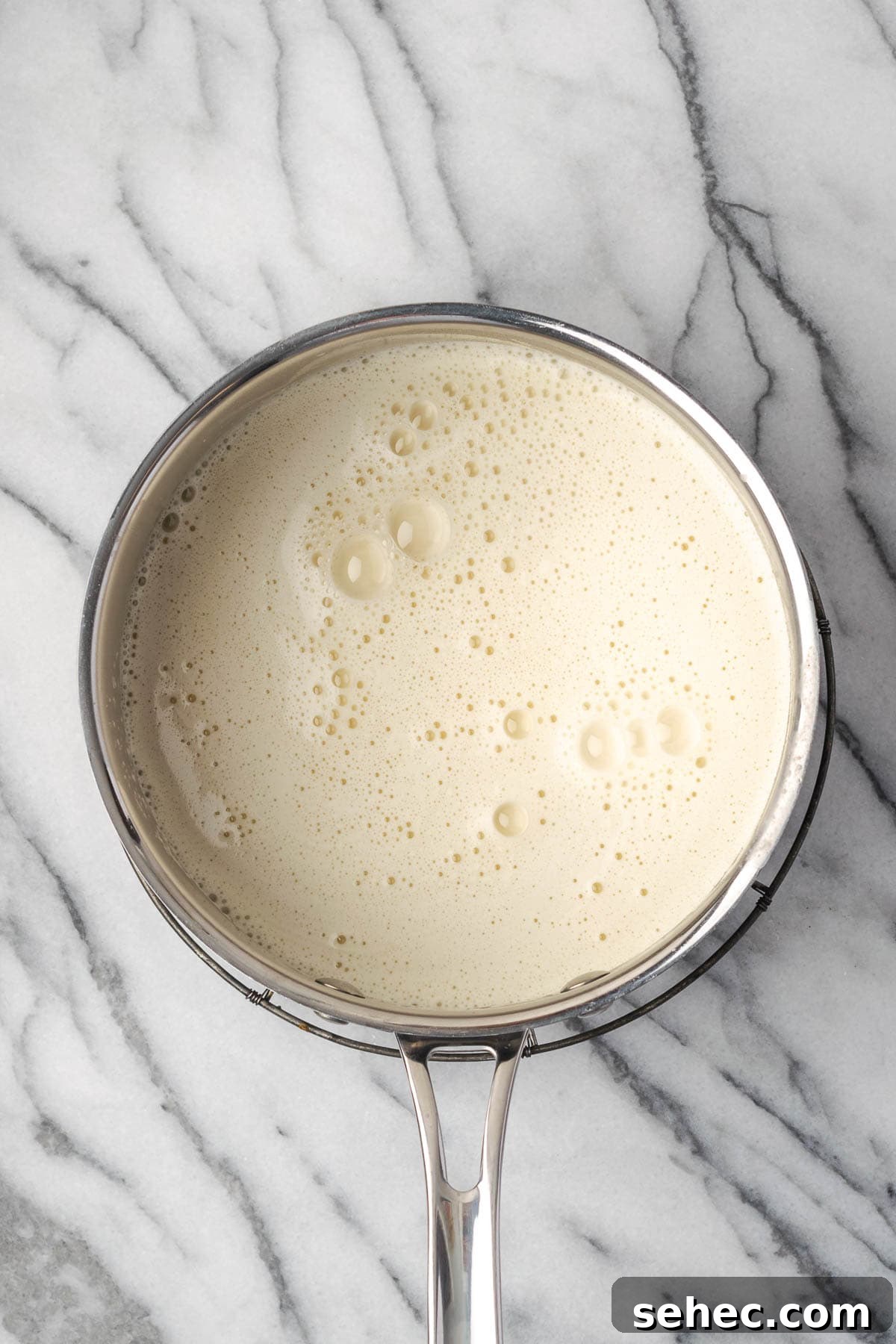 Homemade Banana Pudding Recipe From Scratch 7 Pudding mixture in a saucepan.