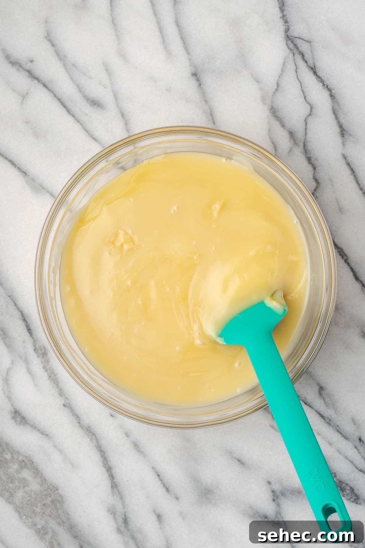 Homemade Banana Pudding Recipe From Scratch 9 Sweetened condensed milk being stirred into the vanilla pudding.