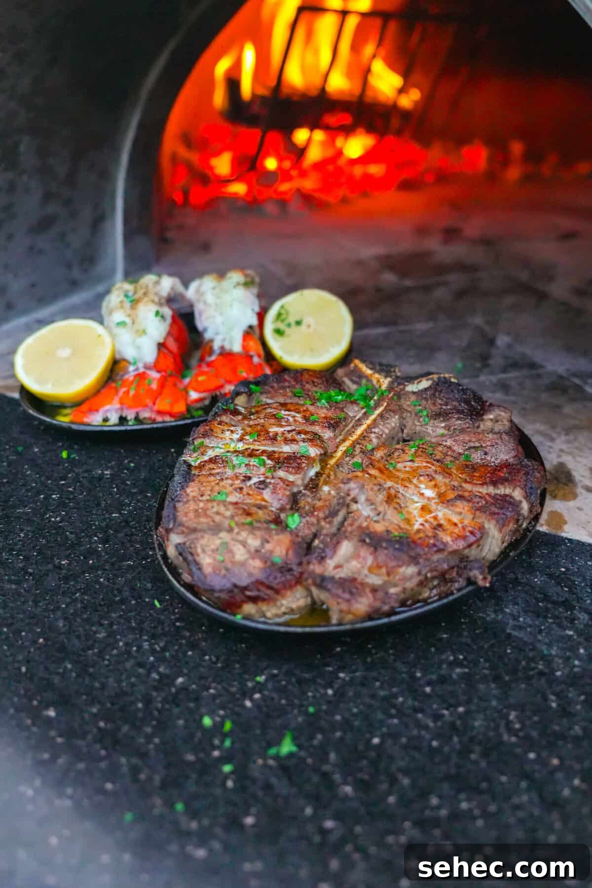 Peter Luger Surf and Turf Steak and Lobster Recipe 3 Seasoned T-bone steak after a searing in a hot skillet by the fire.