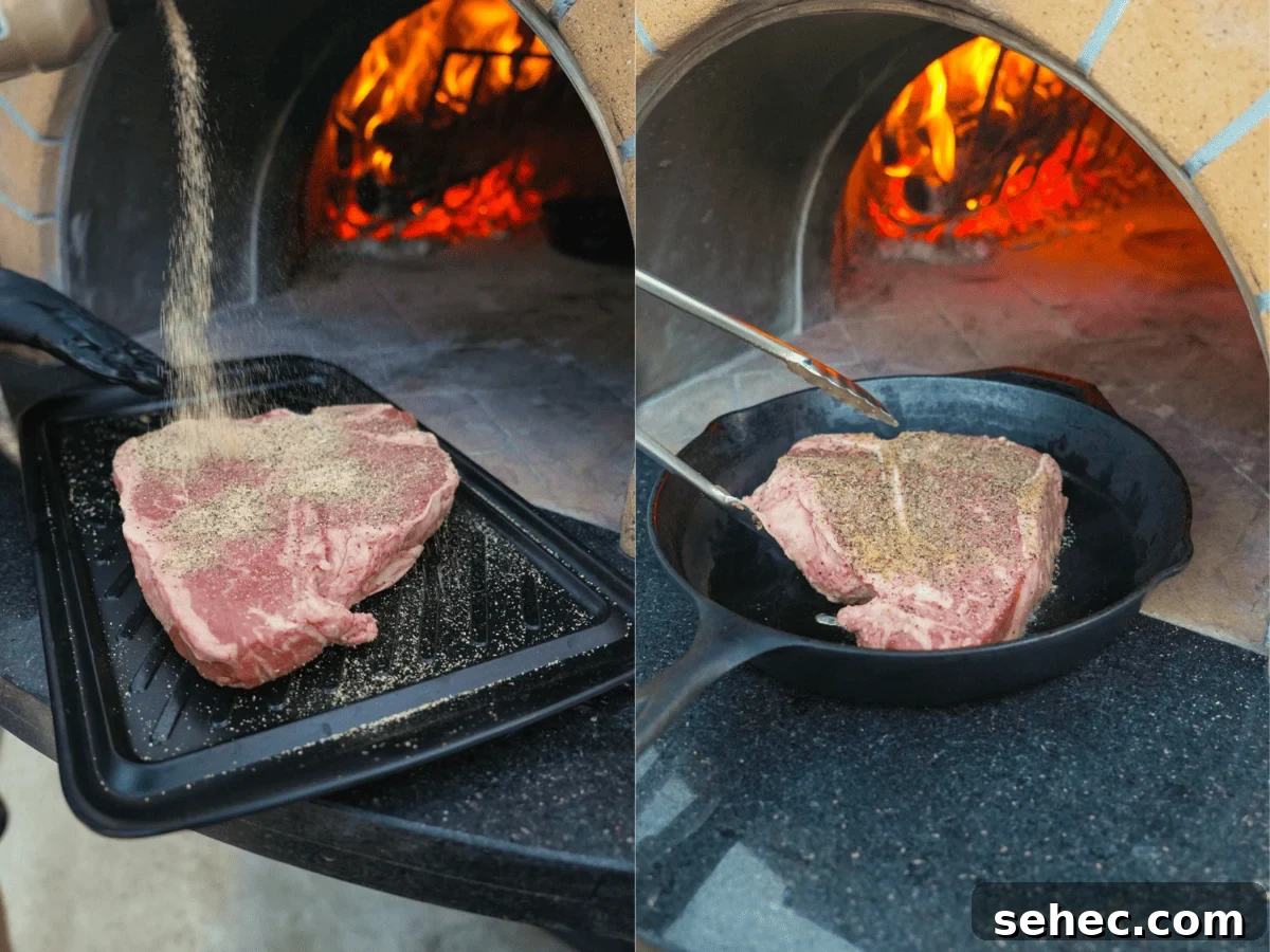 Peter Luger Surf and Turf Steak and Lobster Recipe 5 Raw T-bone steak being seasoned with salt and pepper before searing in a hot skillet by the fire.