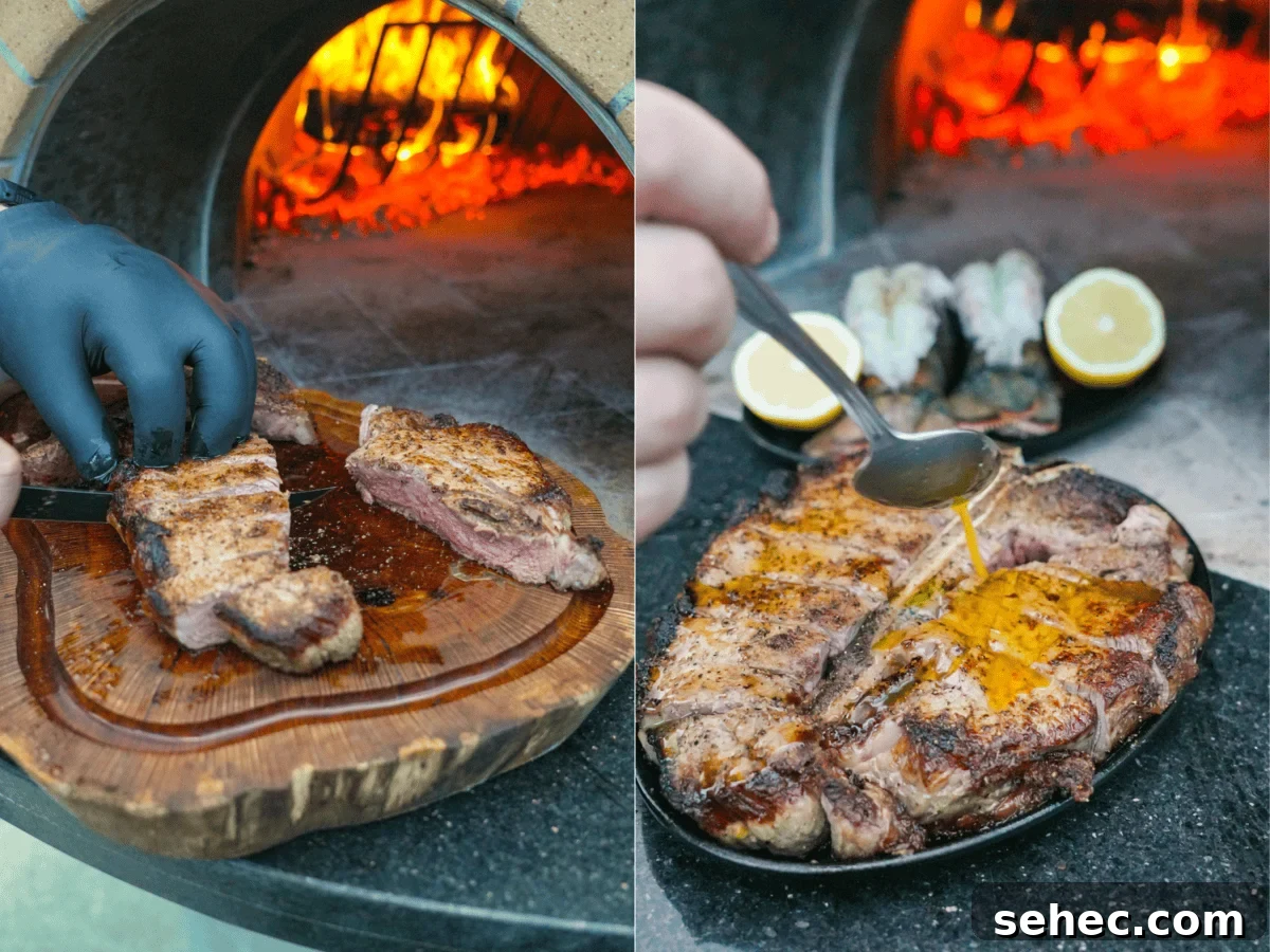 Peter Luger Surf and Turf Steak and Lobster Recipe 8 Derek Wolf slicing steak and pouring melted butter over surf and turf platter with lemon garnish by the fire.