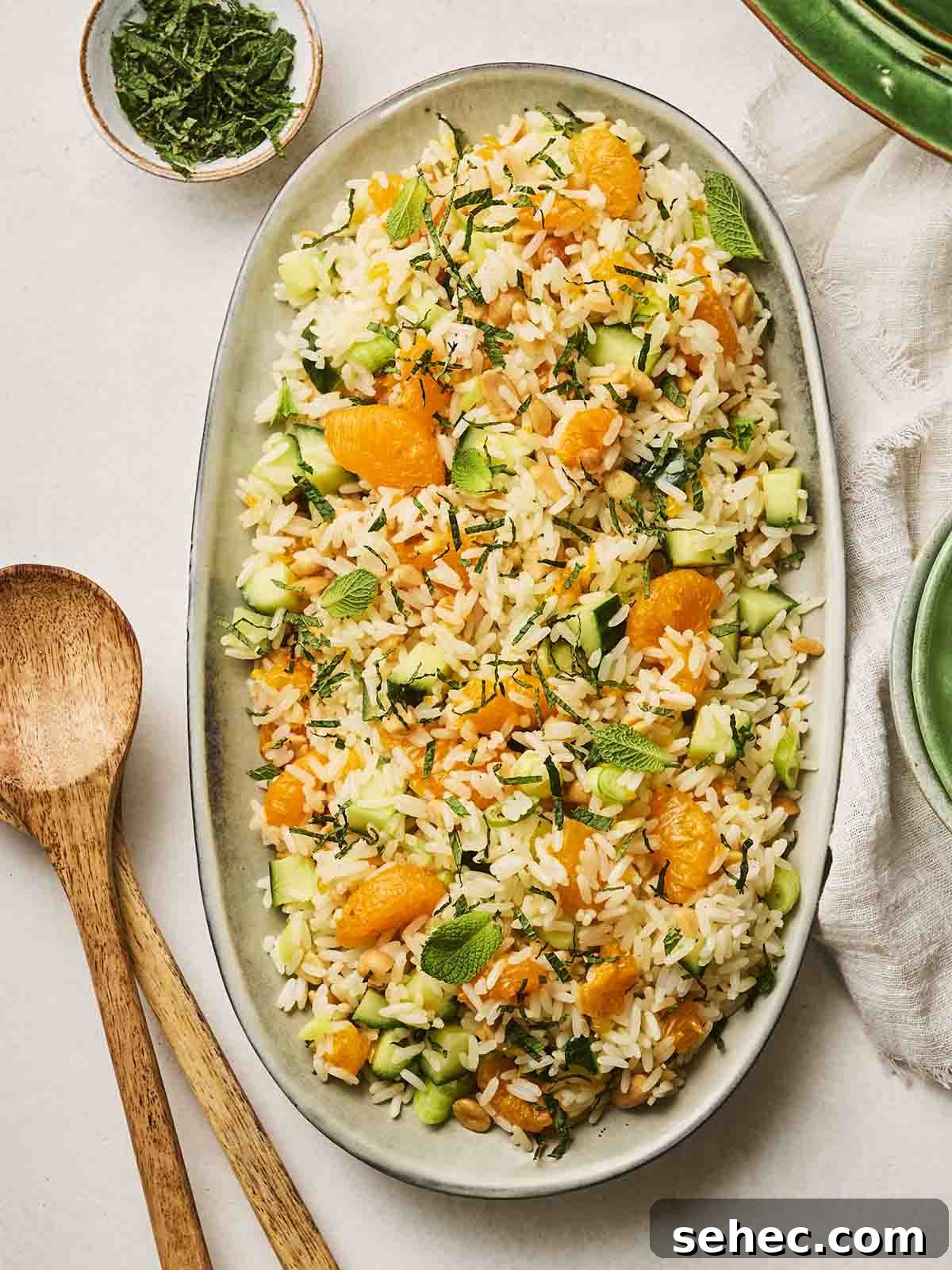 Rice Salad with Fresh Vegetables and Herbs 3 A colourful rice salad on a white platter.