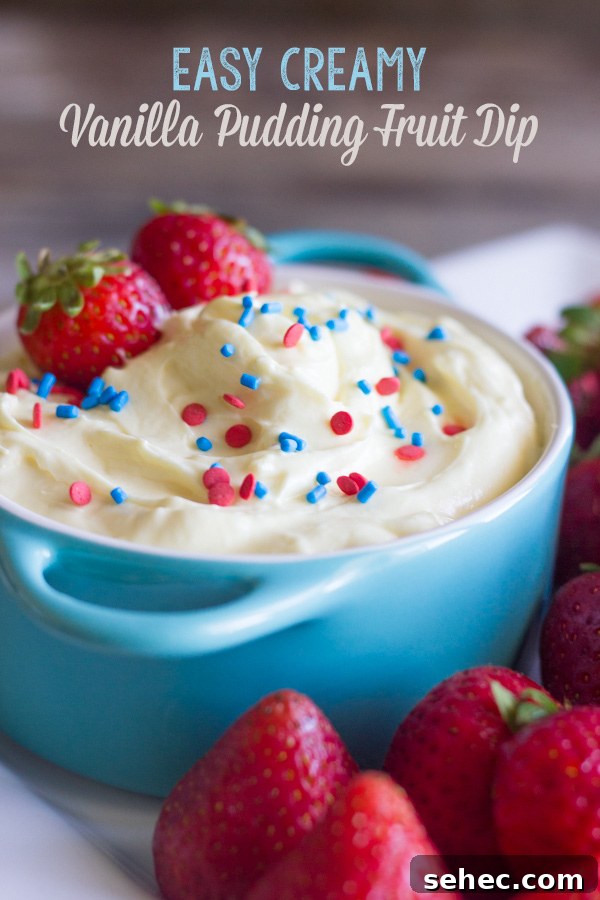 Creamy Vanilla Pudding Fruit Dip Recipe 2 Easy creamy vanilla pudding fruit dip in a bowl topped with sprinkles and fresh strawberries, surrounded by more fresh strawberries on a platter.