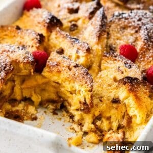 Panettone Bread and Butter Pudding Recipe 13 Large white rectangular dish of Panettone Bread and Butter Pudding, a serve having been removed.